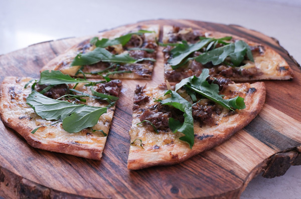 Sausage and arugula pizza