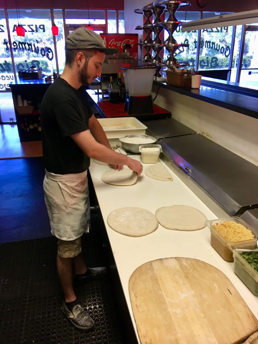 One of our team members making pizza fresh