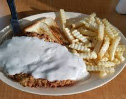 Chicken fried steak with side of fries